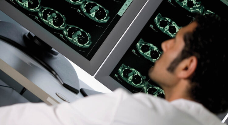 Male doctor examining a monitor looking for radiation