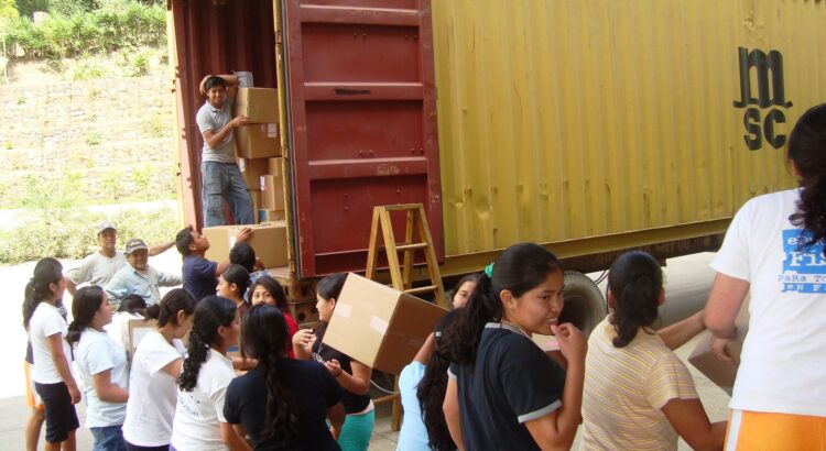 Girls unloading supplies at clinica Medica Maria