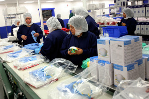 On Oct. 20, 2014, warehouse workers at Medline Industries in Mundelein, Illinois, assembled personal protection equipment (PPE) kits, which typically include a hooded body suit, face shield, boot covers, mask, gloves, Epi-clenz hand sanitizer and a biohazard bag. These items can be used by healthcare professionals who are treating patients with the Ebola virus.