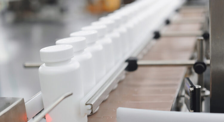 Shot of plastic medicine bottles moving along a conveyor
