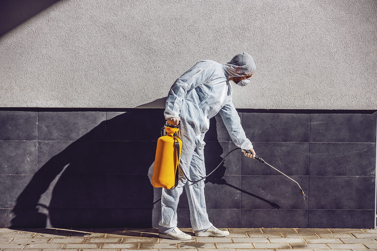 Cleaning and Disinfection outside around buildings, the coronavirus epidemic. Professional teams for disinfection efforts. Infection prevention and control of epidemic. Protective suit and mask. Professional specialist full protective cleaning outside.